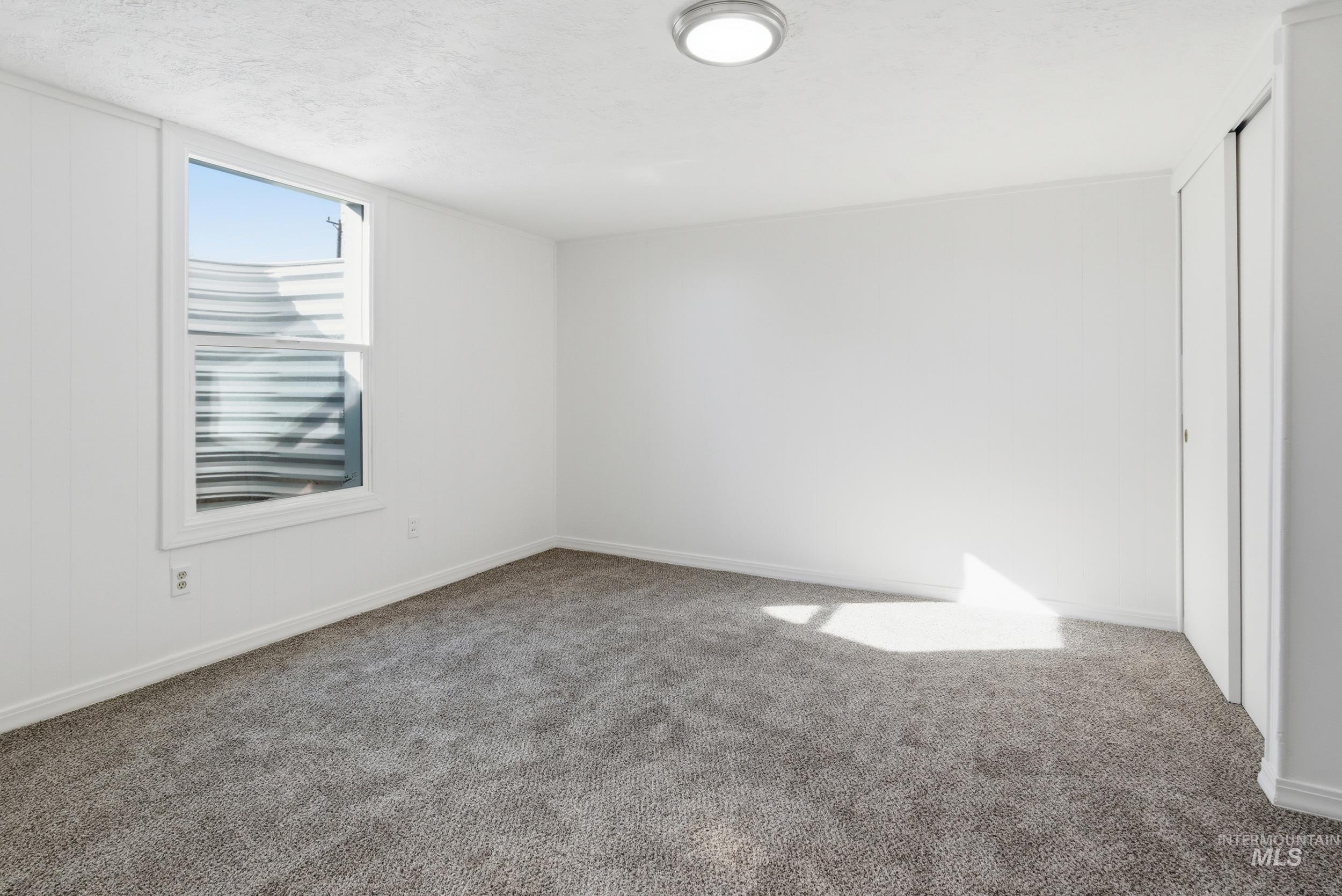107 West Main Street Declo, ID 83323 - Photo 21 of 32 Unfurnished bedroom with carpet flooring and a textured ceiling
