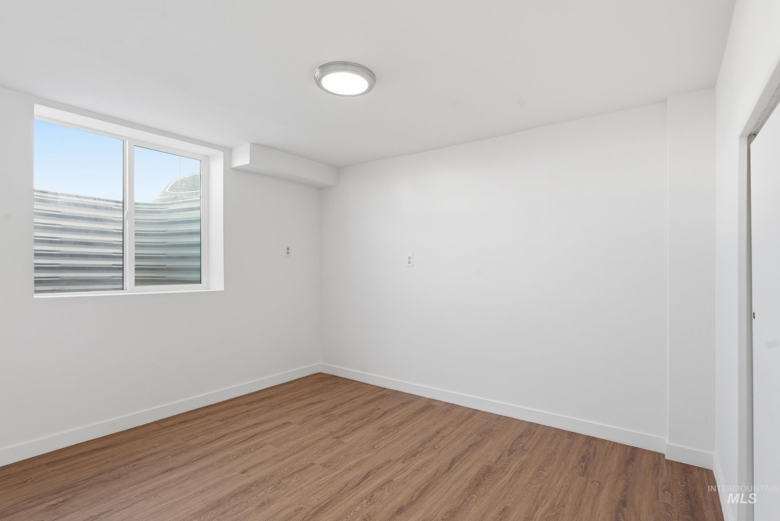 107 West Main Street Declo, ID 83323 - Photo 23 of 32 Empty room featuring wood finished floors and baseboards