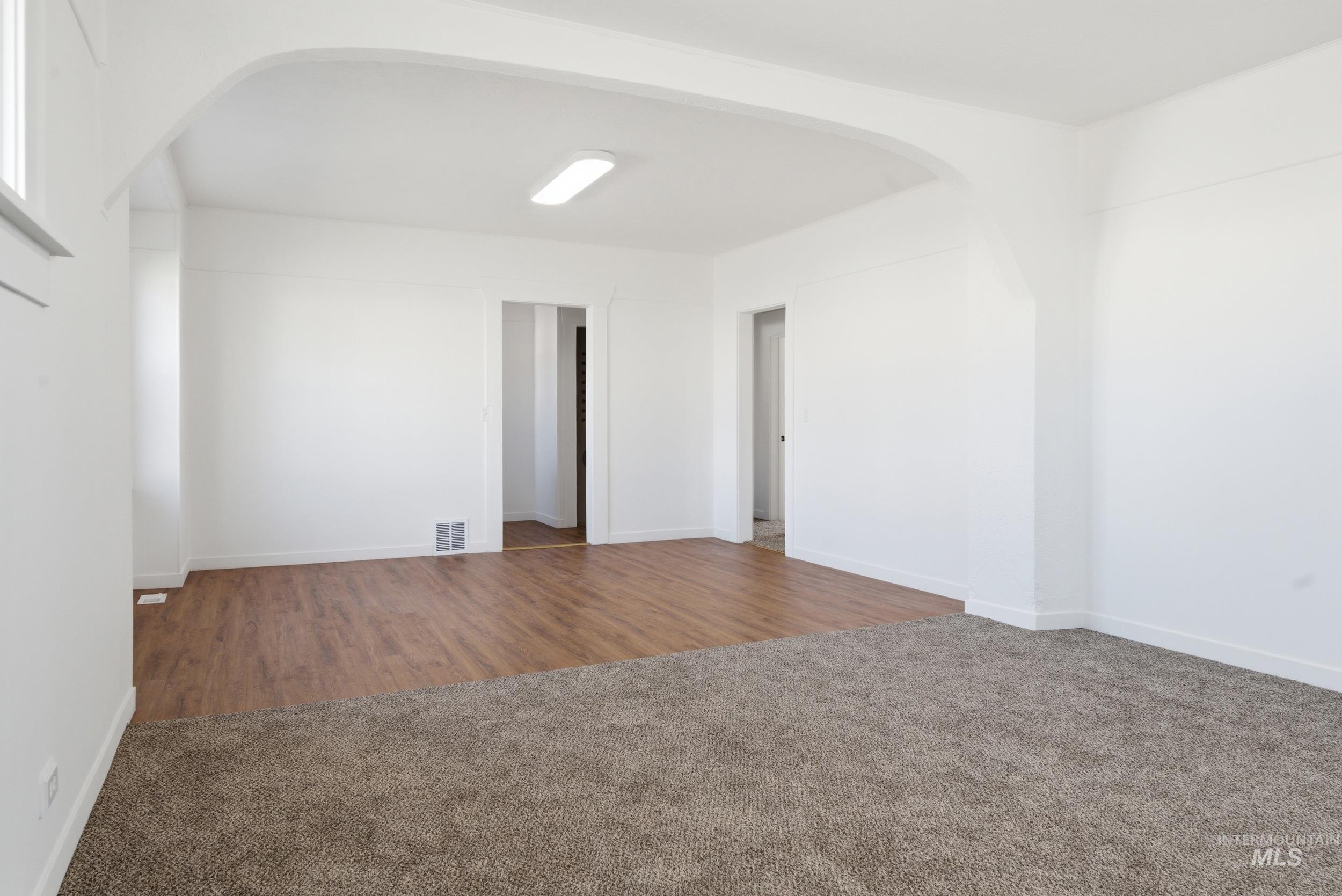107 West Main Street Declo, ID 83323 - Photo 9 of 32 Unfurnished room featuring arched walkways and carpet