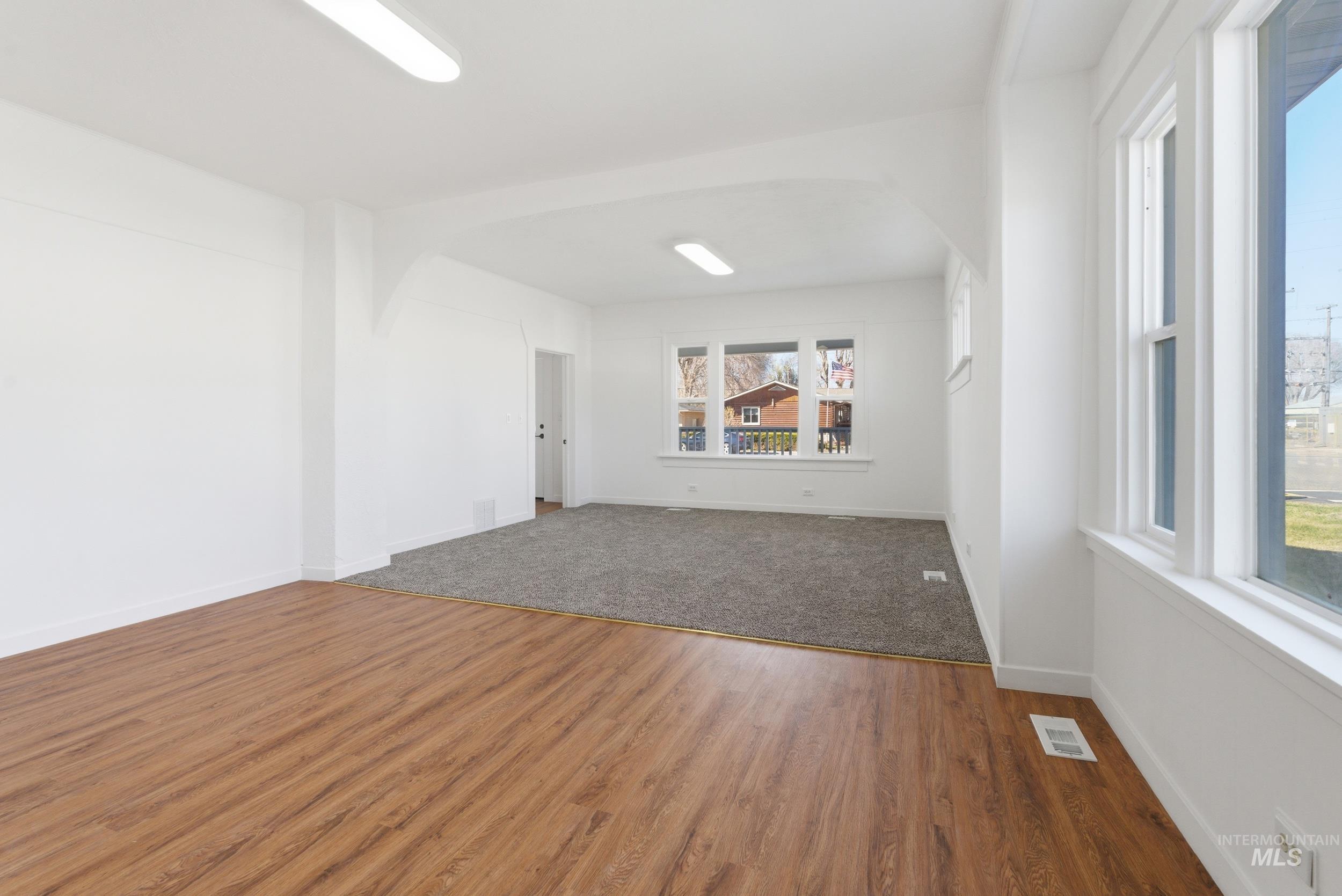 107 West Main Street Declo, ID 83323 - Photo 10 of 32 Unfurnished room with arched walkways and wood finished floors