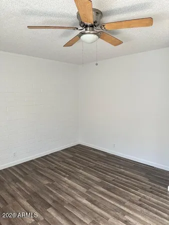 a view of a room with wooden floor and fan