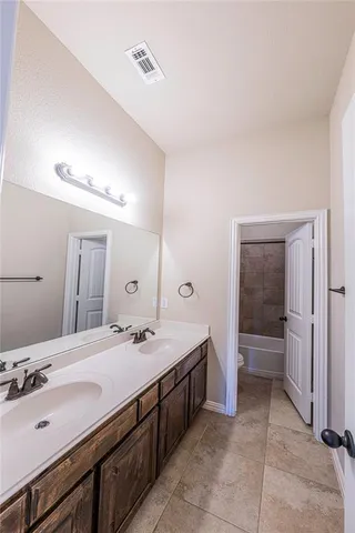 an empty room with ceiling fan and window