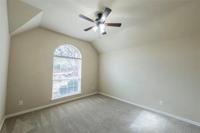 a view of a house with wooden fence and a porch