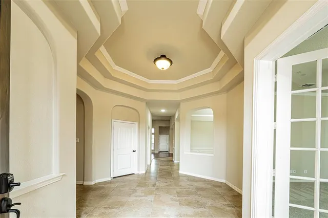 a view of a hallway with wooden shelves