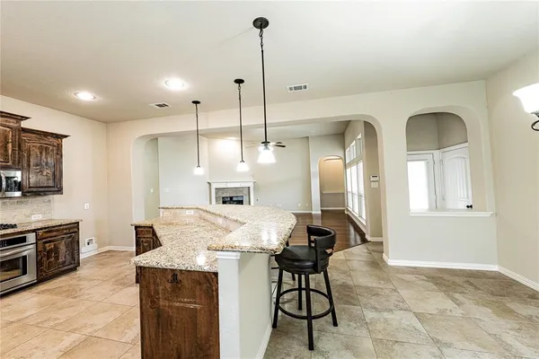 a view of a kitchen with microwave and cabinets