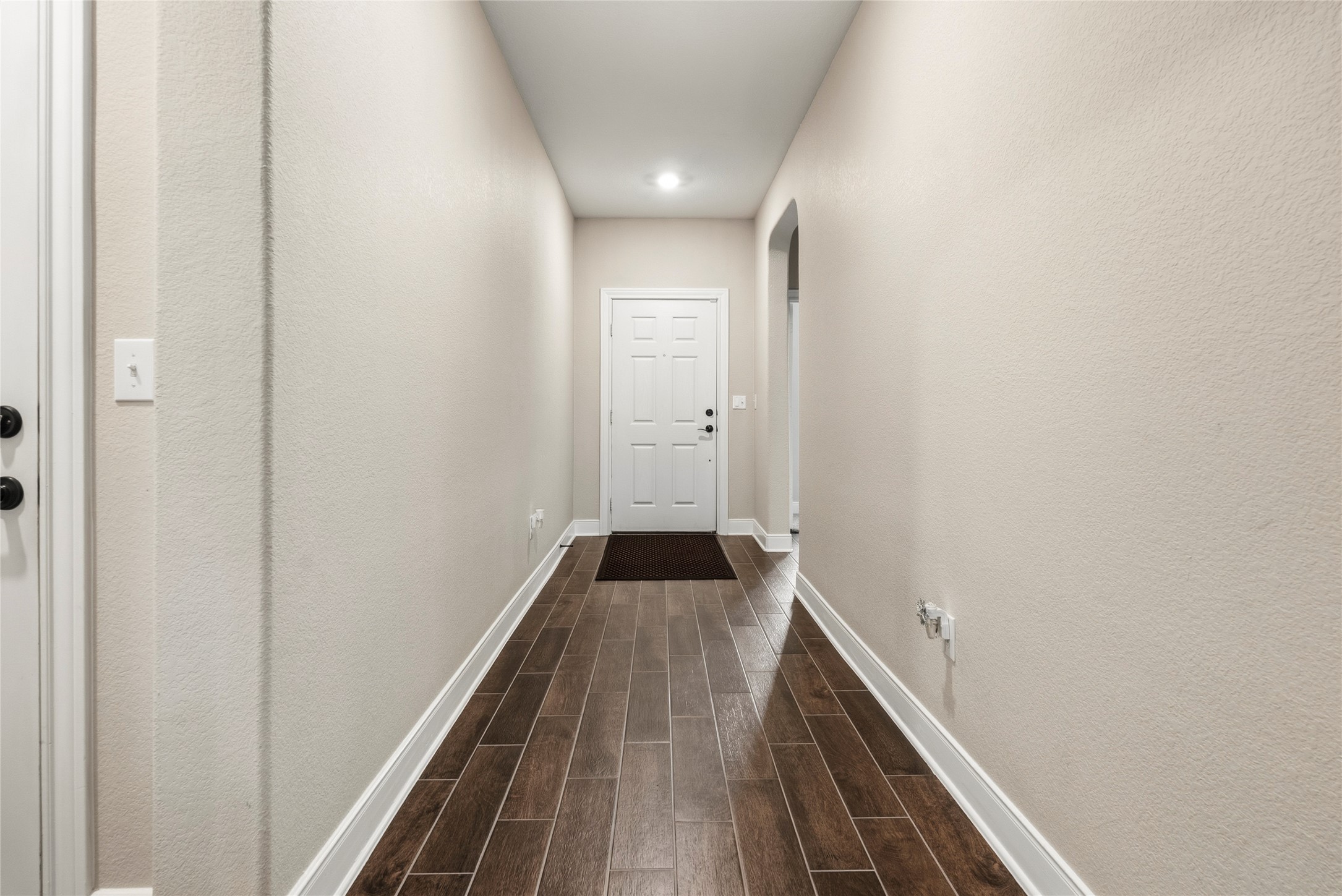 105 West Point Way Elgin, TX 78621 - Photo 27 of 27 Inviting entryway featuring wood-finish flooring, light neutral wall tones, white baseboards, and a recessed ceiling light