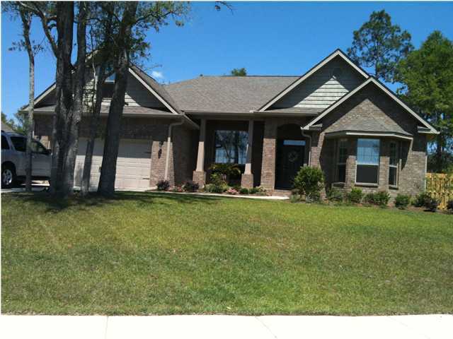 663 Red Fern Road Crestview, FL 32536 - Photo 1 of 12 a front view of a house with a garden