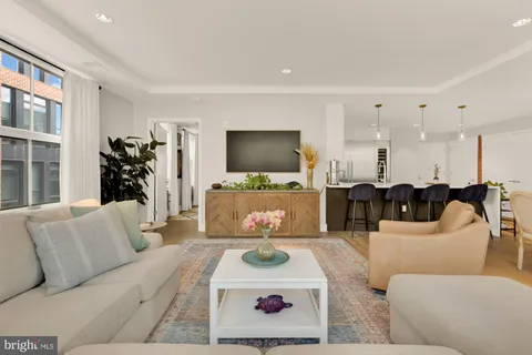 a view of a workspace with furniture and a flat screen tv