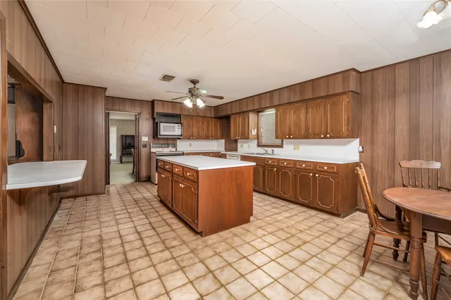 a kitchen with a cabinets a sink and a stove top oven