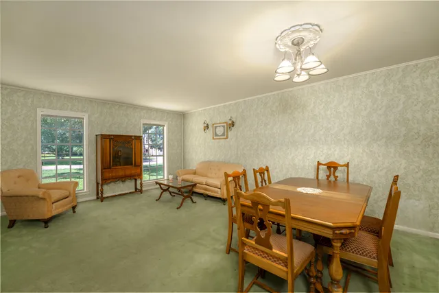 a view of a dining room with furniture and chandelier