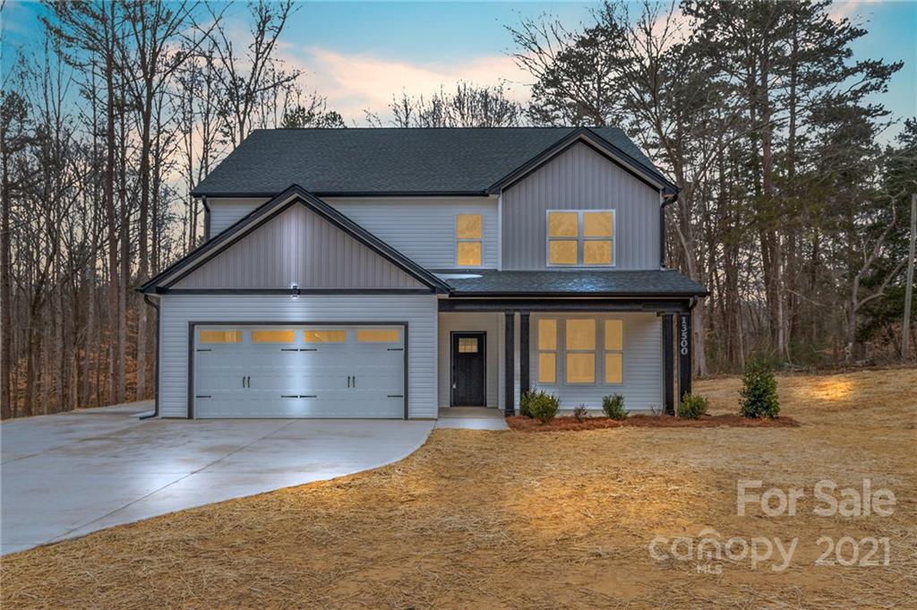 13500 Old Camden Road Midland, NC 28107 - Photo 1 of 41 a front view of a house with a yard and garage