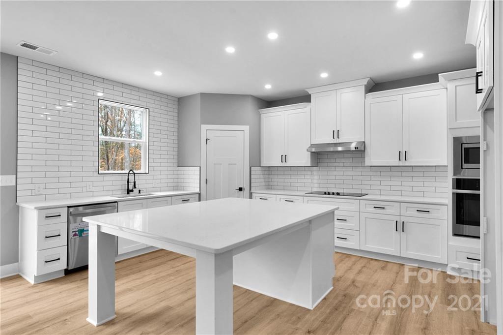 13500 Old Camden Road Midland, NC 28107 - Photo 15 of 41 a kitchen with a sink stainless steel appliances and white cabinets