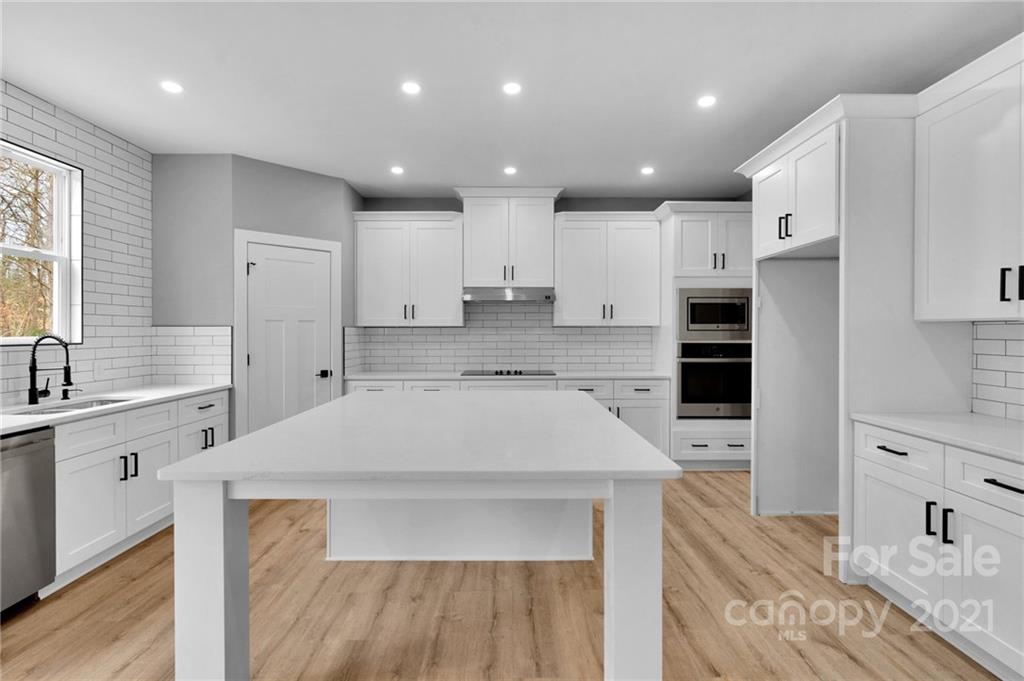 13500 Old Camden Road Midland, NC 28107 - Photo 16 of 41 a kitchen with kitchen island a sink stainless steel appliances and cabinets