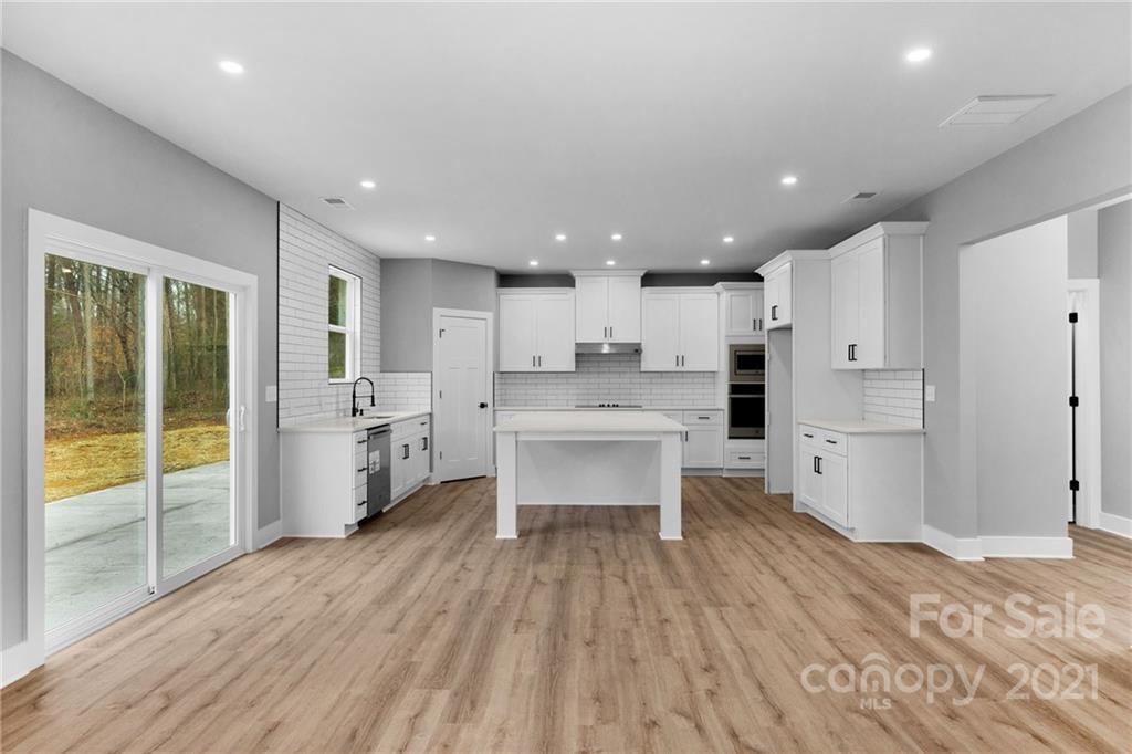 13500 Old Camden Road Midland, NC 28107 - Photo 22 of 41 a large kitchen with a large counter top a sink stainless steel appliances and cabinets