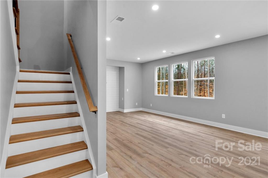 13500 Old Camden Road Midland, NC 28107 - Photo 27 of 41 a view of an empty room with wooden floor and stairs