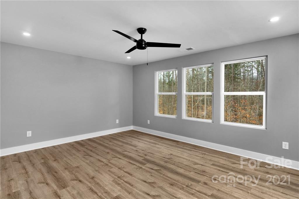 13500 Old Camden Road Midland, NC 28107 - Photo 28 of 41 a view of an empty room with wooden floor and a window