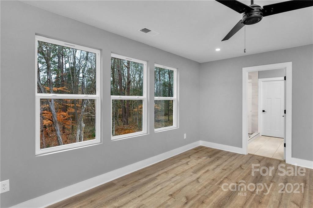 13500 Old Camden Road Midland, NC 28107 - Photo 29 of 41 a view of an empty room with a window and wooden floor