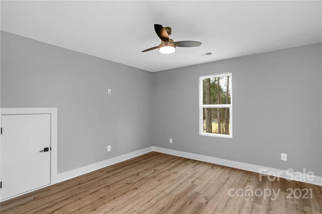 13500 Old Camden Road Midland, NC 28107 - Photo 35 of 41 an empty room with wooden floor and windows