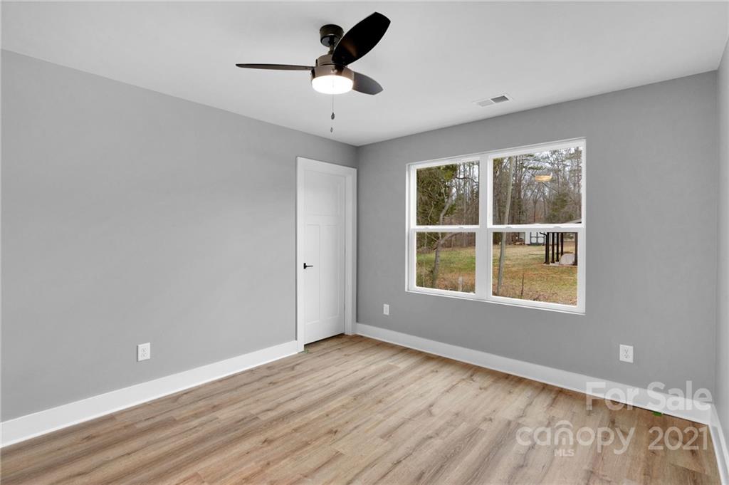 13500 Old Camden Road Midland, NC 28107 - Photo 36 of 41 wooden floor in an empty room with a window