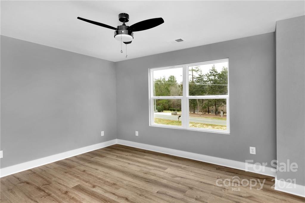 13500 Old Camden Road Midland, NC 28107 - Photo 37 of 41 an empty room with wooden floor and windows