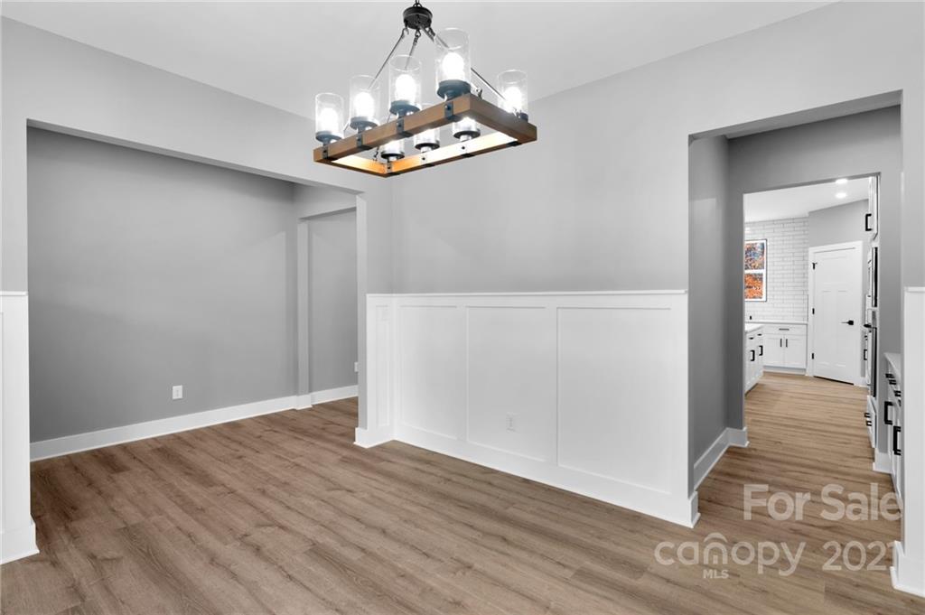 13500 Old Camden Road Midland, NC 28107 - Photo 10 of 41 wooden floor in an empty room with a chandelier