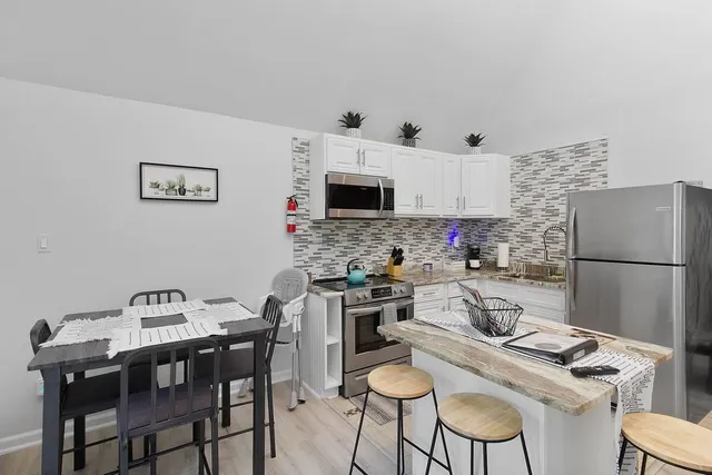 a kitchen with a dining table and chairs