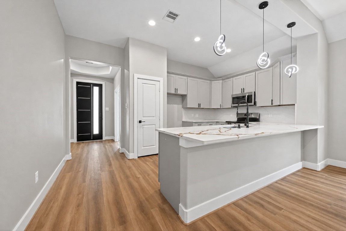 12431 Green Ridge Drive Willis, TX 77318 - Photo 11 of 37 Thoughtfully designed kitchen featuring a large island, ample cabinetry, and an open flow to the main living areas.