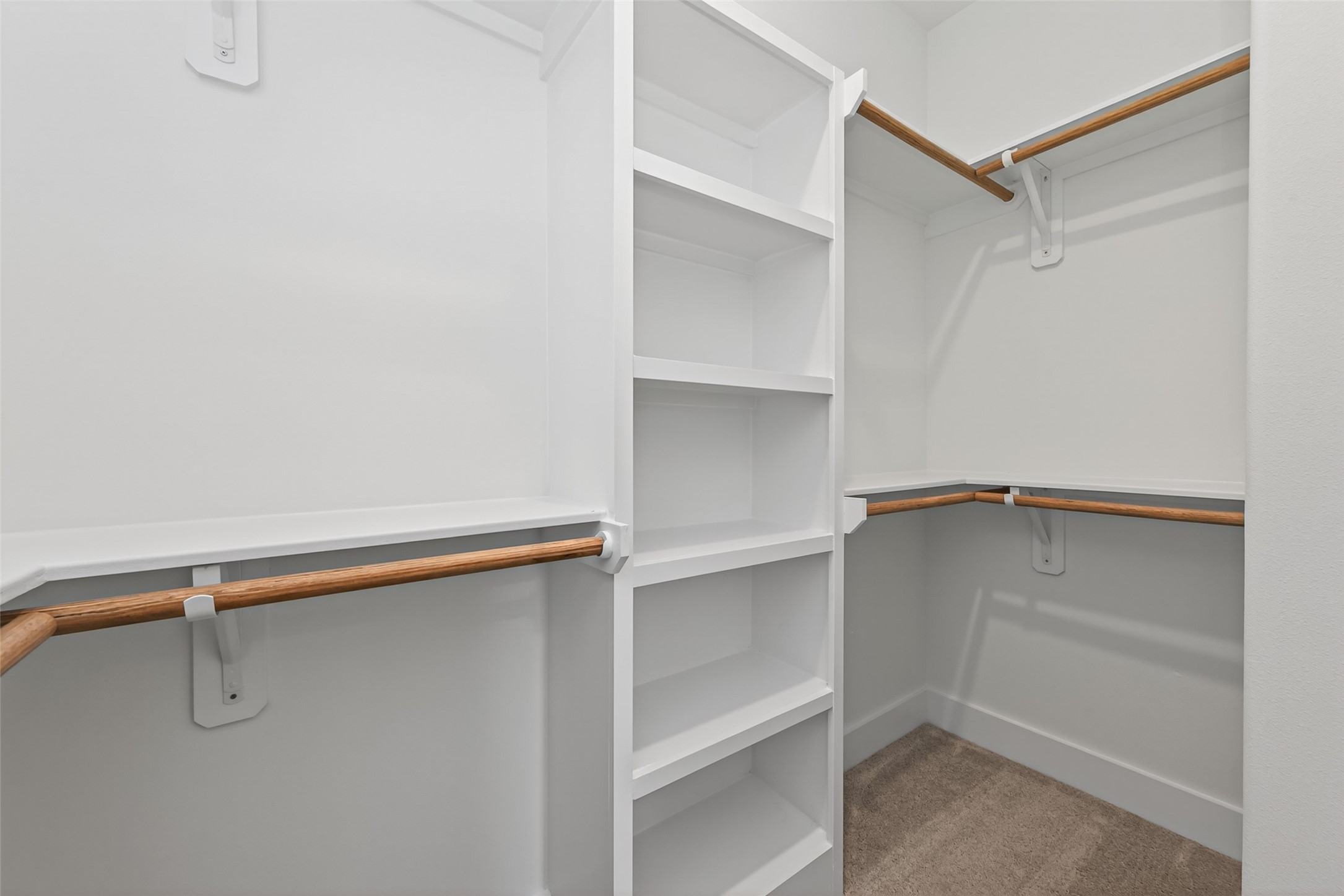 12431 Green Ridge Drive Willis, TX 77318 - Photo 20 of 37 Walk-in closet with custom cabinetry offering plenty of storage and organization space.