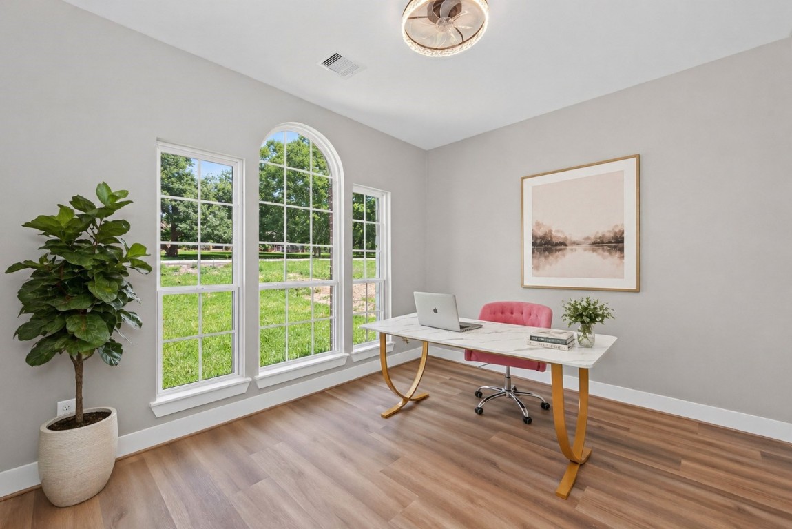 12431 Green Ridge Drive Willis, TX 77318 - Photo 24 of 37 Bright home office with large arched windows offering plenty of natural light, perfect for remote work or study.