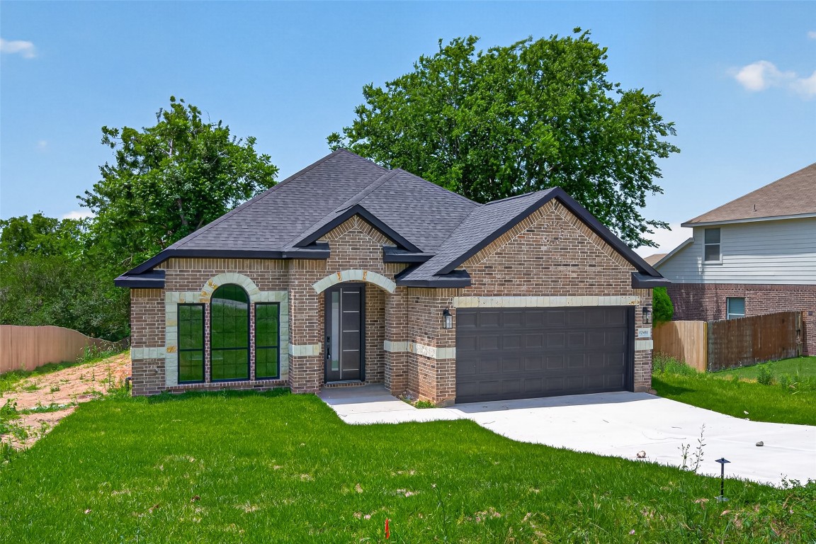 12431 Green Ridge Drive Willis, TX 77318 - Photo 3 of 37 This charming home features a brick exterior with a modern design, including large arched windows and a spacious driveway