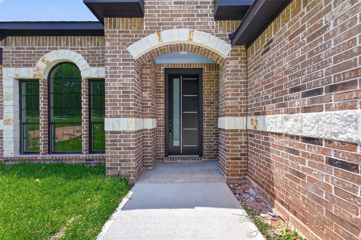 12431 Green Ridge Drive Willis, TX 77318 - Photo 4 of 37 This charming home features a brick exterior with a modern design, including large arched windows and a spacious driveway