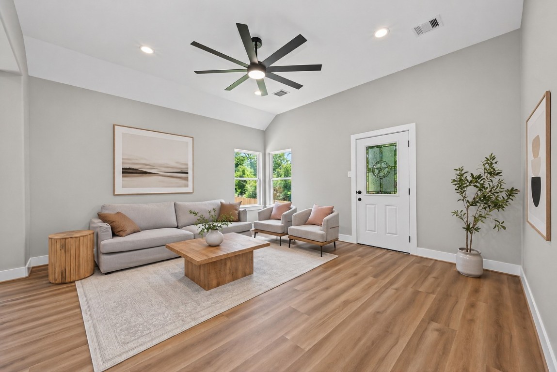 12431 Green Ridge Drive Willis, TX 77318 - Photo 6 of 37 Spacious living area with high ceilings and abundant natural light, overlooking the large backyard—perfect for relaxing or entertaining.