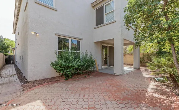 a view of a house with a yard and potted plants