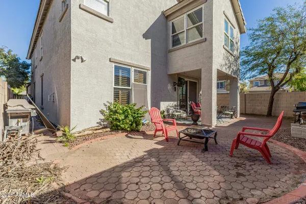 a backyard of a house with outdoor seating