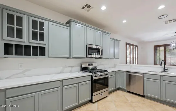 a kitchen with stainless steel appliances a sink stove and microwave