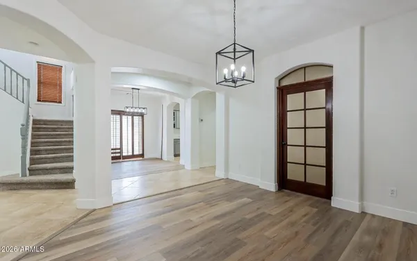 a view of empty room with wooden floor and window