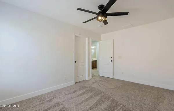 an empty room with a ceiling fan
