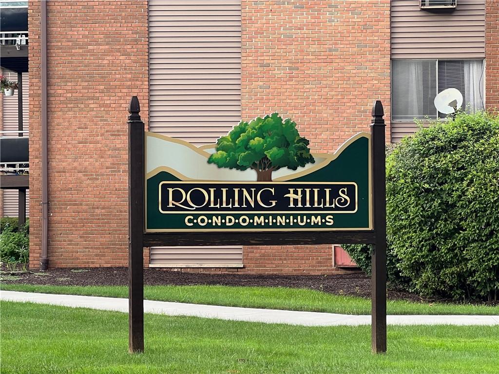 a sign that is on a brick wall