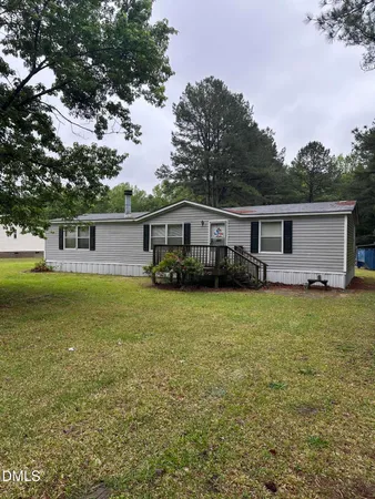 a front view of house with yard space and seating area