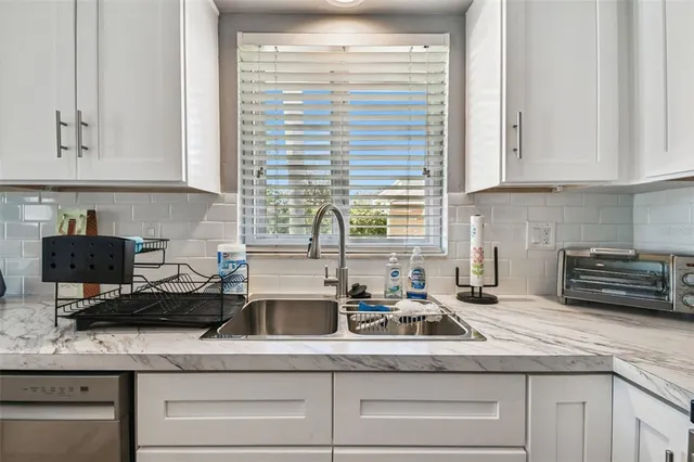 a kitchen with appliances a sink and cabinets