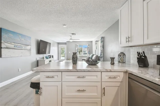 a kitchen with cabinets stainless steel appliances and sink