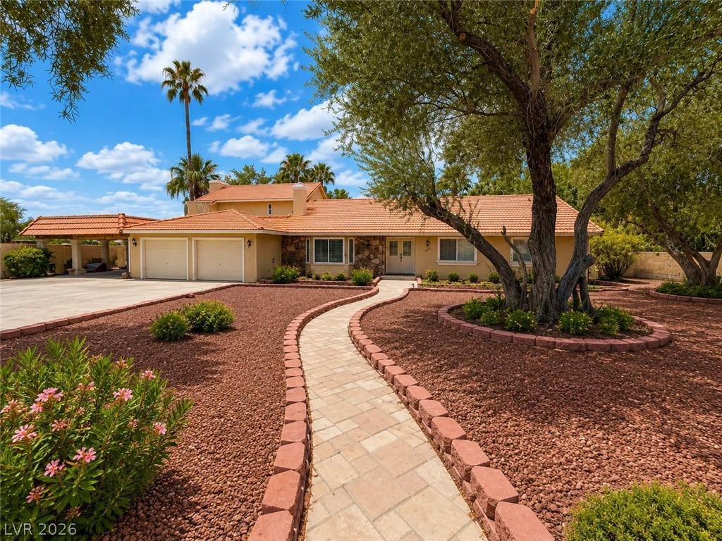 3010 East Viking Road Las Vegas, NV 89121 - Photo 1 of 48 A terracotta-tiled residence welcomes guests along a winding paver walkway.