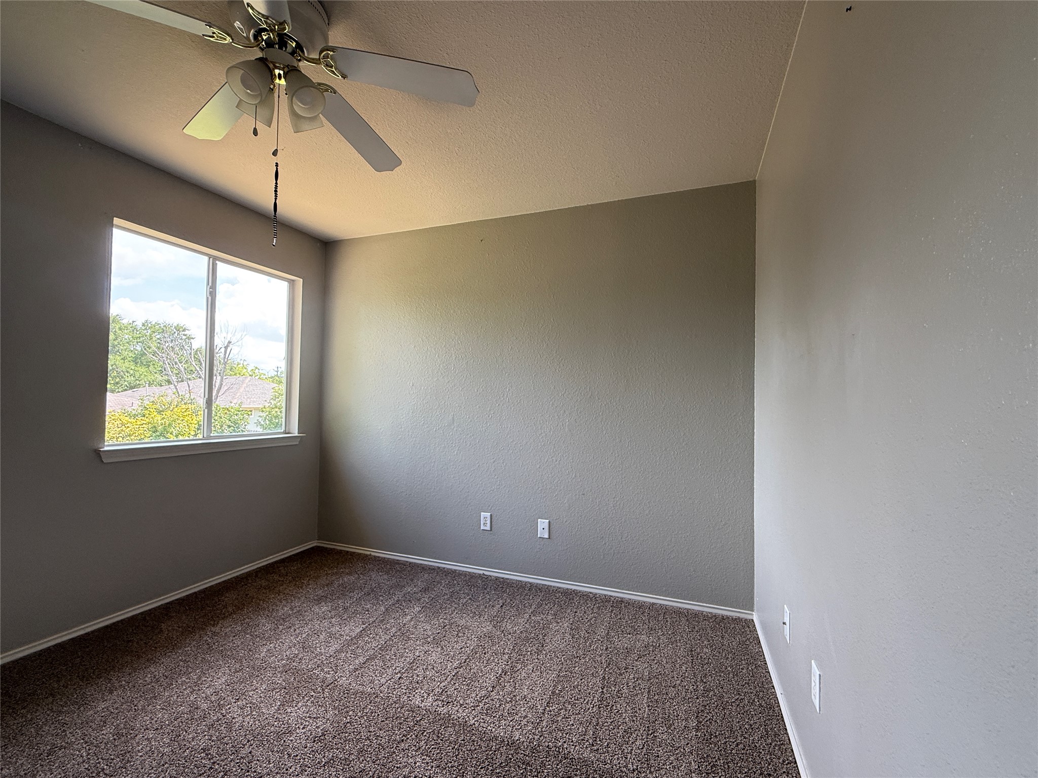 2120 Jester Farms Road Round Rock, TX 78664 - Photo 16 of 28 A well-lit bedroom features plush carpeting and a convenient ceiling fan for comfort.