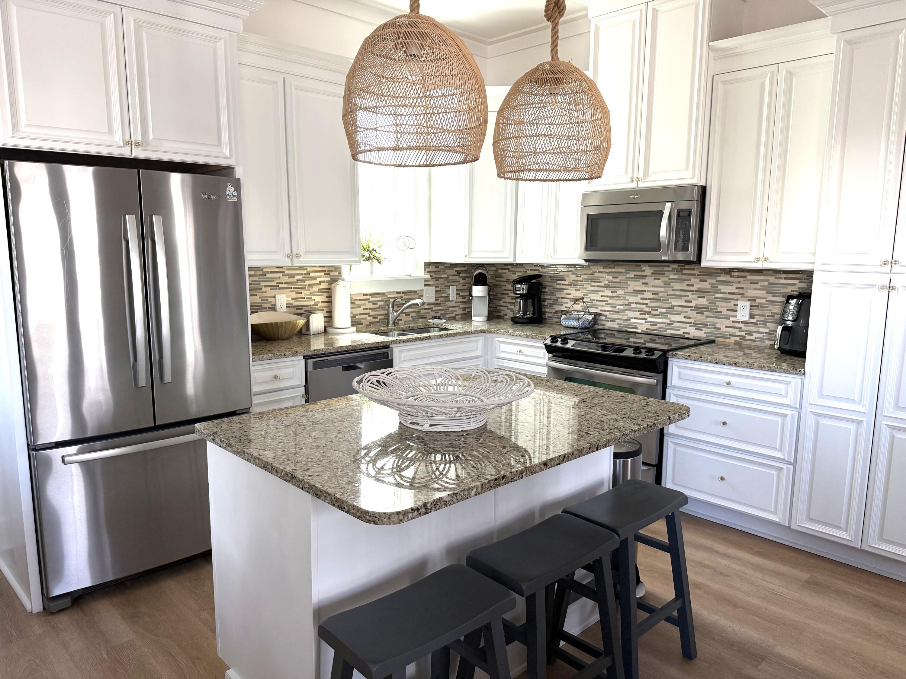 36 Moonlight Beach Lane Inlet Beach, FL 32461 - Photo 11 of 60 a kitchen with stainless steel appliances granite countertop a stove refrigerator and microwave