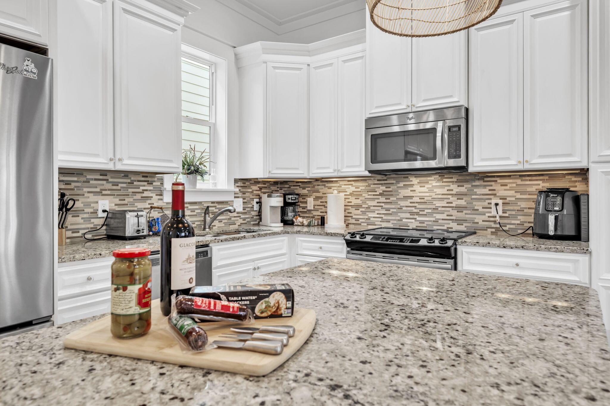 36 Moonlight Beach Lane Inlet Beach, FL 32461 - Photo 13 of 60 a kitchen with stainless steel appliances granite countertop a sink a stove and a microwave