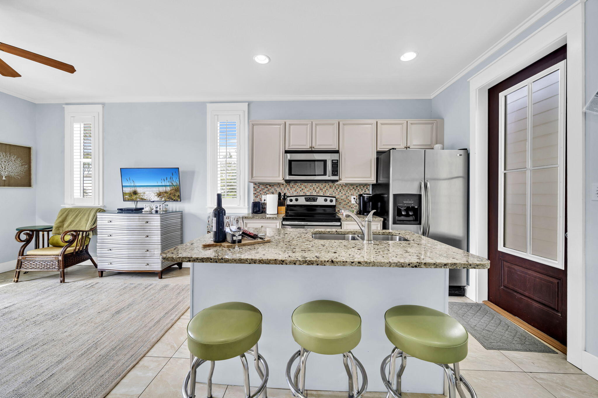 36 Moonlight Beach Lane Inlet Beach, FL 32461 - Photo 37 of 60 a kitchen with stainless steel appliances granite countertop a refrigerator a stove a sink dishwasher a dining table and chairs with wooden floor