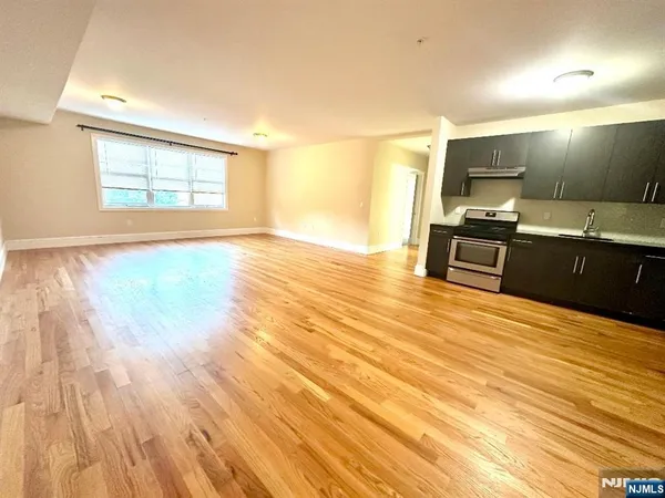 a kitchen with stainless steel appliances wooden floors and wooden cabinets