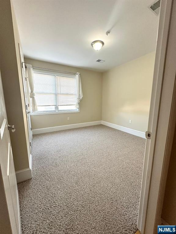 13-23 River Road, Unit 206 Fair Lawn, NJ 07410 - Photo 6 of 6 an empty room with windows