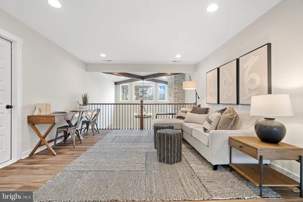 a living room with furniture a wooden floor and a table