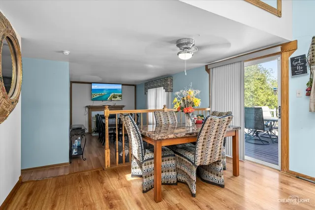a dining room with furniture window and wooden floor